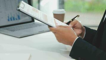 Financial analysts analyze business financial reports on a digital tablet planning investment project during a discussion at a meeting of corporate showing the results of their successful teamwork. video