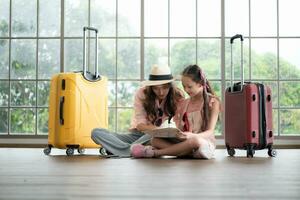 Mother and daughter are happy and ready to travel on a weekend trip photo