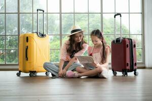 Mother and daughter are happy and ready to travel on a weekend trip photo