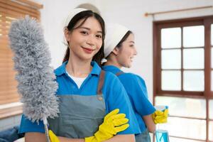 Portrait of asian female cleaning service staff in uniform and rubber gloves, housework concept photo