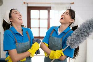 Portrait of asian female cleaning service staff in uniform and rubber gloves, housework concept photo