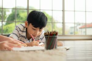 A boy and a daughter from an asian family. The children are having fun in the art of drawing. photo