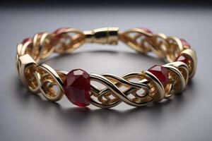 Bracelet with red ruby on a gray background close-up. photo