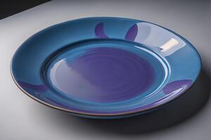 Blue plate on a gray background. Side view. Close-up. photo