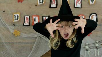 a young girl in a witch costume with her hands up video