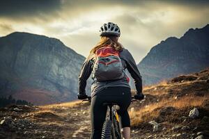 Rear view of a young woman riding a mountain bike in the mountains, A female cyclist riding a cycle on the mountain, rear view, no visible faces, natural background, AI Generated photo