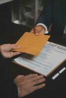 Business and lawyers discussing contract papers with brass scale on desk in office. Law, legal services, advice, justice and law concept picture with film grain effect photo