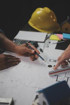 Engineer Teamwork Meeting, Drawing working on blueprint meeting for project working with partner on model building and engineering tools in working site, Construction and structure concept. photo