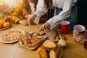 Friends hangout. Young female celebrating birthday party at weekend at home, eating pizza, drinking champagne, party, lifestyle, friendship photo