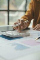 Accounting businessman working on laptop computer and analyzing real estate investment data, Financial and tax systems concept. photo