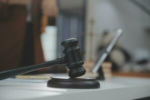 Business and lawyers discussing contract papers with brass scale on desk in office. Law, legal services, advice, justice and law concept picture with film grain effect photo