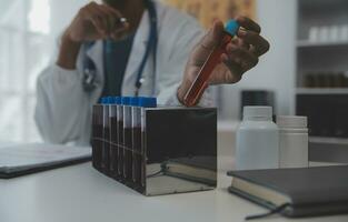 Professional lab. Amazing longhaired medical worker wearing uniform while using microscope during research photo