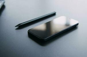 Open laptop with digital tablet and white smartphone. All with isolated screen on old wooden desk. photo