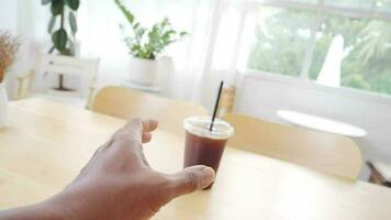 Camera movement Hand holding iced Americano cup video