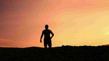 Slow motion. Men practice trail running in the evening. Silhouette of man running video