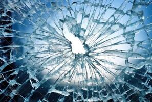 A glass surface that took a bad hit and broke, featuring a big scary hole maybe a bullet created with technology photo
