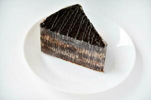 Chocolate cake on a white plate. A sweet snack. Sweetness for tea. photo