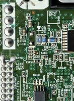 Blue board with radio elements. A chip with a processor and transistors. Diodes and resistors. Microchip. photo