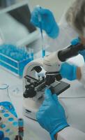 Team of Scientists Choose Between Printed Circuit Board to Work With. In The Background Technologically Advanced Scientific Research Center. photo