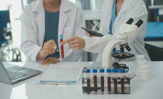 Team of Scientists Choose Between Printed Circuit Board to Work With. In The Background Technologically Advanced Scientific Research Center. photo