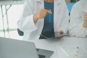 Team of Scientists Choose Between Printed Circuit Board to Work With. In The Background Technologically Advanced Scientific Research Center. photo