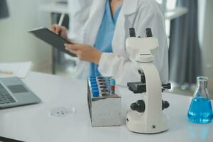 Team of Scientists Choose Between Printed Circuit Board to Work With. In The Background Technologically Advanced Scientific Research Center. photo