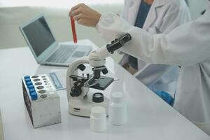 Team of Scientists Choose Between Printed Circuit Board to Work With. In The Background Technologically Advanced Scientific Research Center. photo