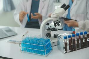 Team of Scientists Choose Between Printed Circuit Board to Work With. In The Background Technologically Advanced Scientific Research Center. photo