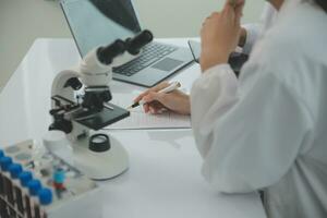 Team of Scientists Choose Between Printed Circuit Board to Work With. In The Background Technologically Advanced Scientific Research Center. photo