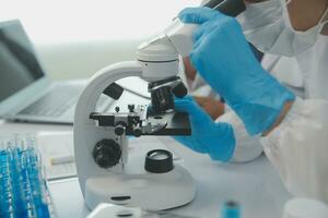 Team of Scientists Choose Between Printed Circuit Board to Work With. In The Background Technologically Advanced Scientific Research Center. photo