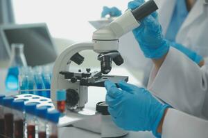 Team of Scientists Choose Between Printed Circuit Board to Work With. In The Background Technologically Advanced Scientific Research Center. photo
