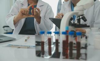 Team of Scientists Choose Between Printed Circuit Board to Work With. In The Background Technologically Advanced Scientific Research Center. photo