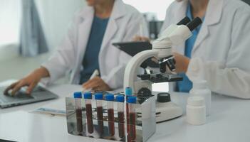 Team of Scientists Choose Between Printed Circuit Board to Work With. In The Background Technologically Advanced Scientific Research Center. photo