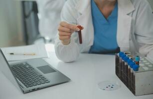 Team of Scientists Choose Between Printed Circuit Board to Work With. In The Background Technologically Advanced Scientific Research Center. photo