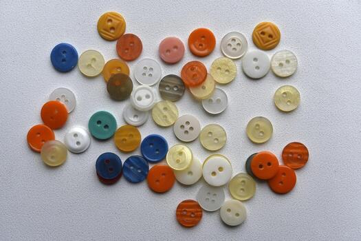Multicolored buttons on a white background. Round buttons from clothes. photo