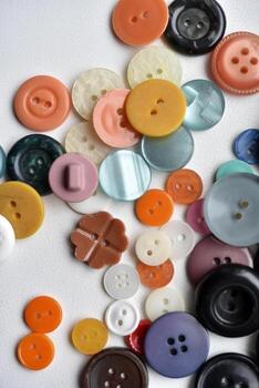 Multicolored buttons on a white background. Round buttons from clothes. photo