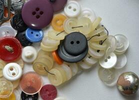 Multicolored buttons on a white background. Round buttons from clothes. photo