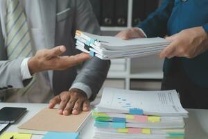 analyst or financial advisor provides advice on securities analysis and stock market management. Businessman showing documents through graphs and charts. Brainstorm and work together photo