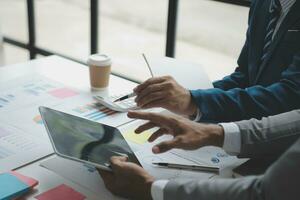 analyst or financial advisor provides advice on securities analysis and stock market management. Businessman showing documents through graphs and charts. Brainstorm and work together photo