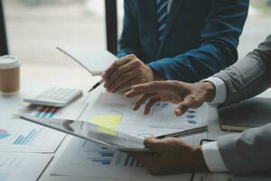 analyst or financial advisor provides advice on securities analysis and stock market management. Businessman showing documents through graphs and charts. Brainstorm and work together photo
