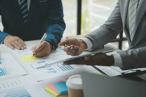 analyst or financial advisor provides advice on securities analysis and stock market management. Businessman showing documents through graphs and charts. Brainstorm and work together photo