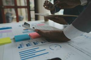 analyst or financial advisor provides advice on securities analysis and stock market management. Businessman showing documents through graphs and charts. Brainstorm and work together photo