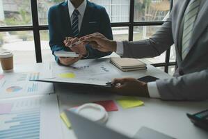 analyst or financial advisor provides advice on securities analysis and stock market management. Businessman showing documents through graphs and charts. Brainstorm and work together photo