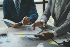 analyst or financial advisor provides advice on securities analysis and stock market management. Businessman showing documents through graphs and charts. Brainstorm and work together photo