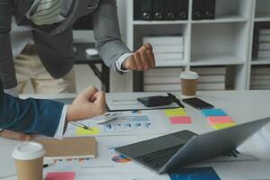 analyst or financial advisor provides advice on securities analysis and stock market management. Businessman showing documents through graphs and charts. Brainstorm and work together photo