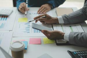 analyst or financial advisor provides advice on securities analysis and stock market management. Businessman showing documents through graphs and charts. Brainstorm and work together photo
