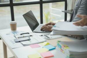 analyst or financial advisor provides advice on securities analysis and stock market management. Businessman showing documents through graphs and charts. Brainstorm and work together photo