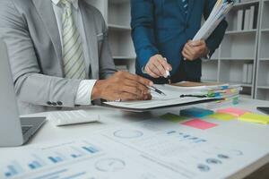 analyst or financial advisor provides advice on securities analysis and stock market management. Businessman showing documents through graphs and charts. Brainstorm and work together photo