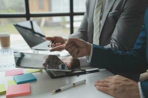 analyst or financial advisor provides advice on securities analysis and stock market management. Businessman showing documents through graphs and charts. Brainstorm and work together photo