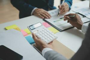 analyst or financial advisor provides advice on securities analysis and stock market management. Businessman showing documents through graphs and charts. Brainstorm and work together photo